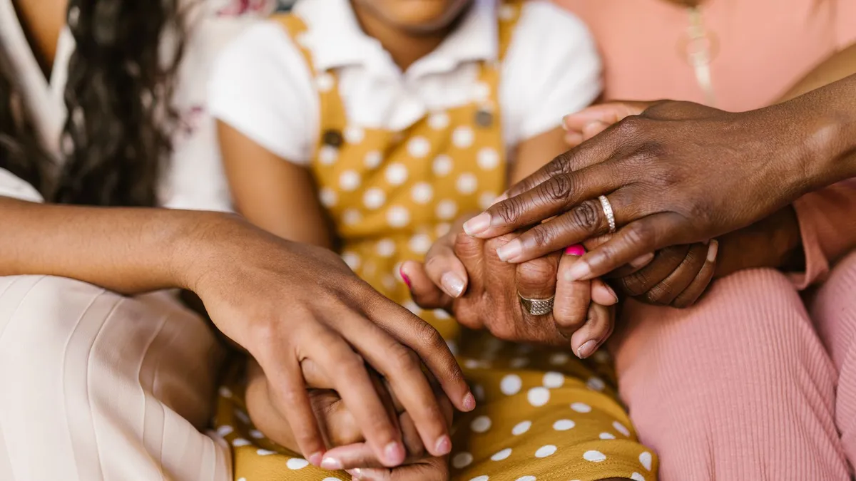Family members holding hands in support