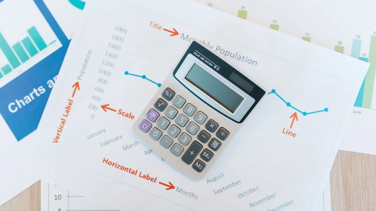 A person reviewing household finances and planning documents at a desk