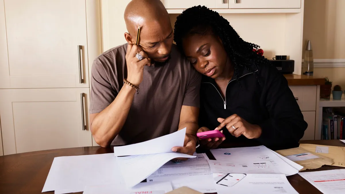 A couple reviewing financial paperwork together at home
